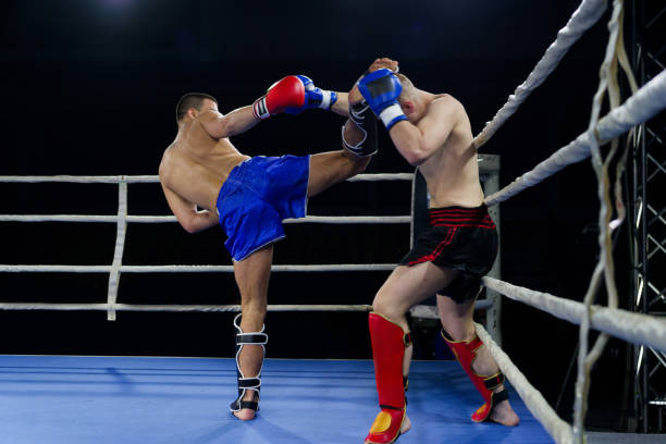 istock Kickboxing rivals unleash powerful leg strikes in a thrilling match. 2160626407