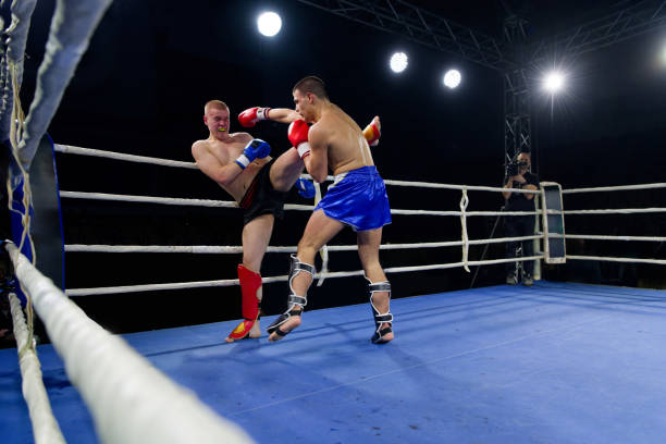 istock Kickboxing rivals unleash powerful leg strikes in a thrilling match. 2160627657