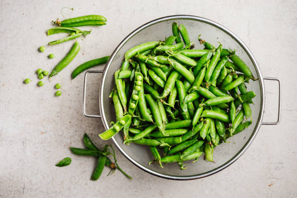 istock Fresh green peas in pods. 2160629023