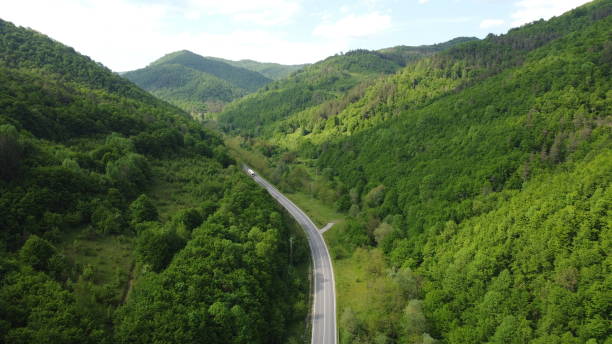 istock traffic in a mountain pass with passing cargo trucks 2160630473