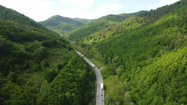 istock traffic in a mountain pass with passing cargo trucks 2160630476