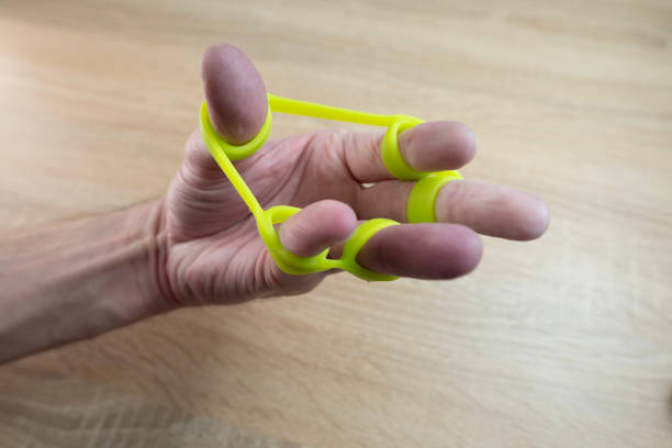 istock Green rubber hand grip tool used for developing hand strength and rehabilitation after injuries or paralysis 2160632574