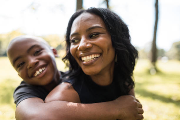 istock mom and son embracing at the park 2160634505