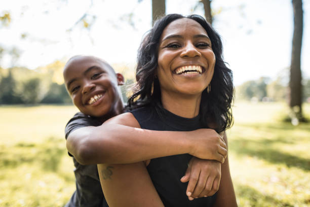 istock mom and son embracing at the park 2160634531