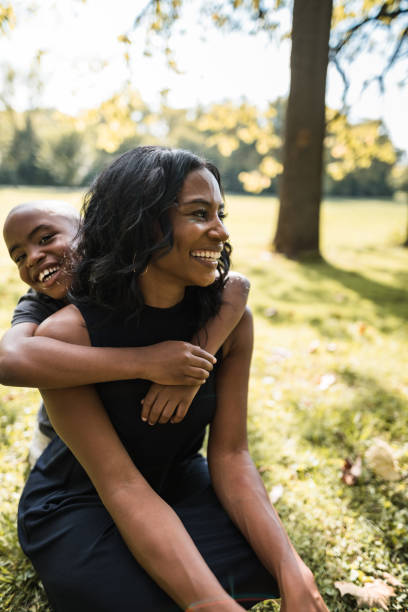 istock mom and son embracing at the park 2160634565