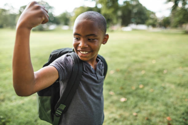 istock little kid showing the muscle 2160634575