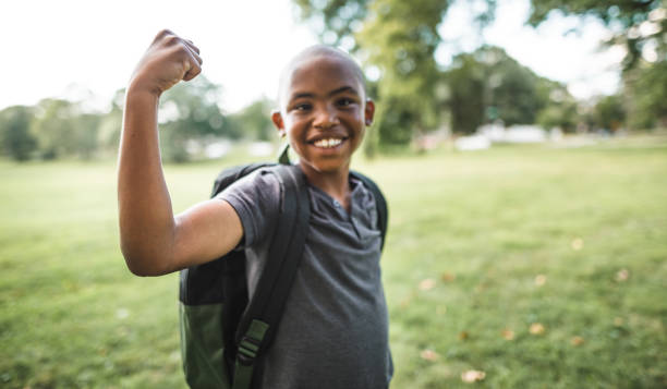 istock little kid showing the muscle 2160634583
