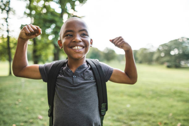 istock little kid showing the muscle 2160634596