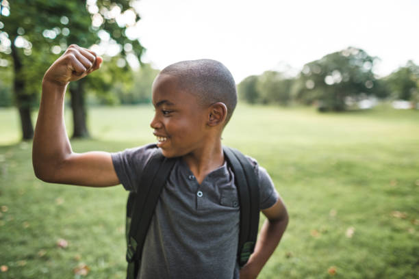 istock little kid showing the muscle 2160634635