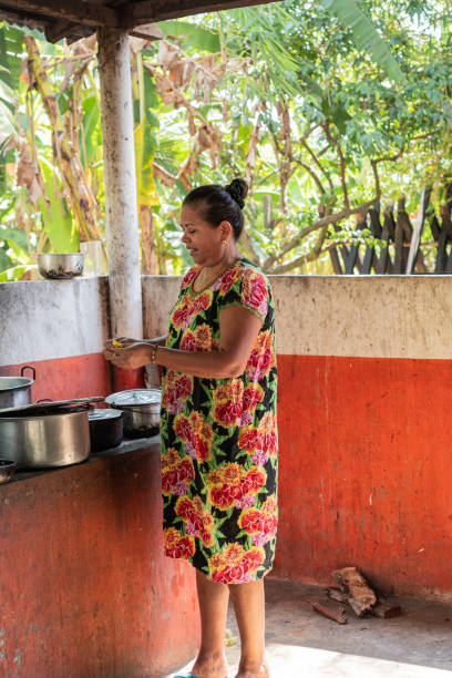 istock Women Cooking in Outdoor Kitchen with Tropical Background 2160636562