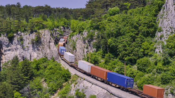 istock Freight train travels along a railway through rugged, rocky landscape 2160640125