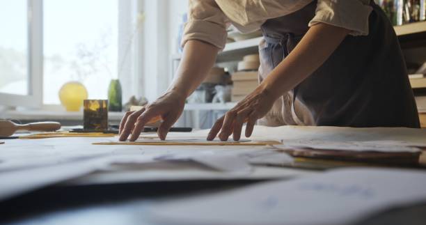 istock Craftswoman Using Hand Glass Cutter for Shaping Mirror in Artistic Studio 2160640870