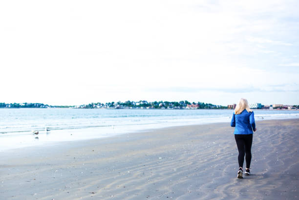 Active Senior Woman Jogging on Beach