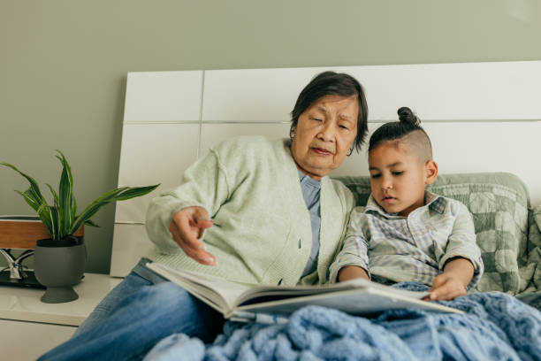 istock Granny reading a book for grandkid 2160645507