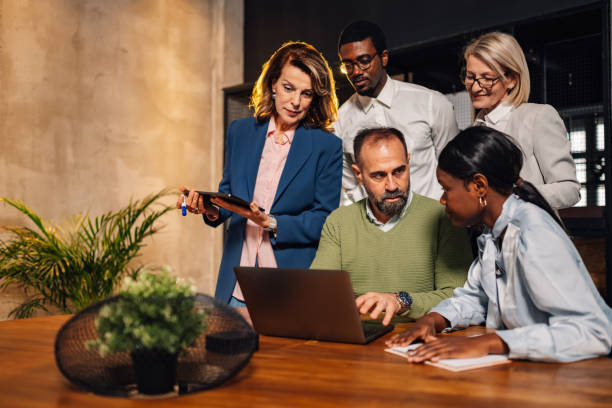 istock Small group of interracial experts collaborating on project at boardroom 2160645612
