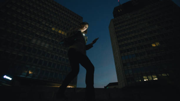 istock Nighttime Stroll with Smartphone by Professional Female 2160645824