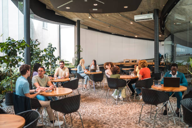 istock Diverse Individuals Immersed in Coffee Bliss at Modern Cafeteria 2160646799