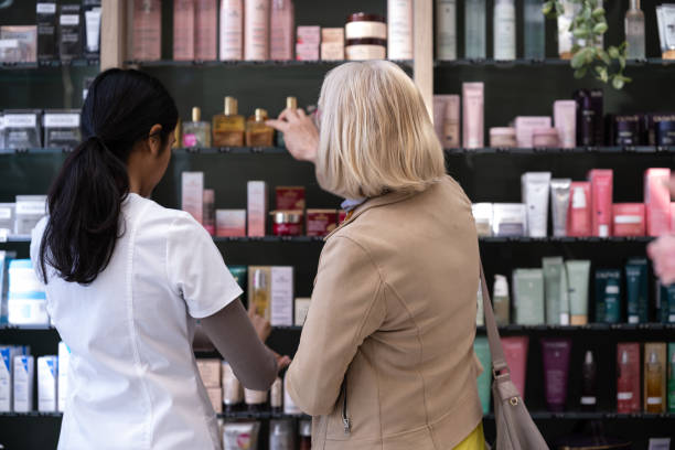 istock Pharmacists in a pharmacy with a customer 2160652293