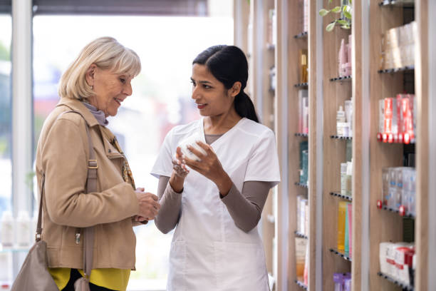 istock Pharmacists in a pharmacy with a customer 2160652298