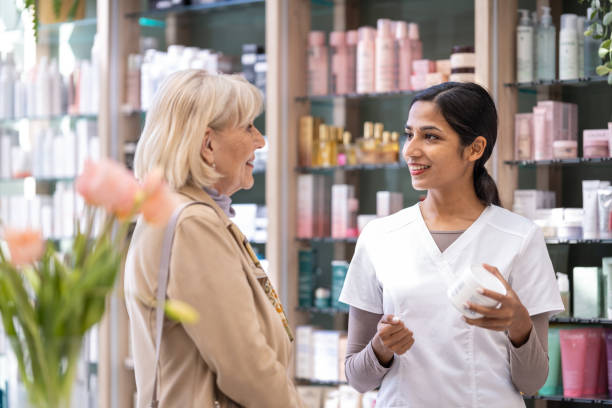 istock Pharmacists in a pharmacy with a customer 2160652308