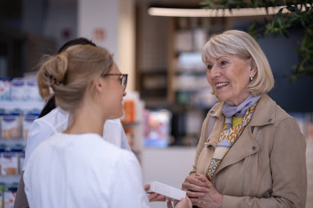 istock Multiracial pharmacists in a drug store with a customer 2160652552
