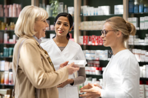 istock Multiracial pharmacists in a drug store with a customer 2160652572