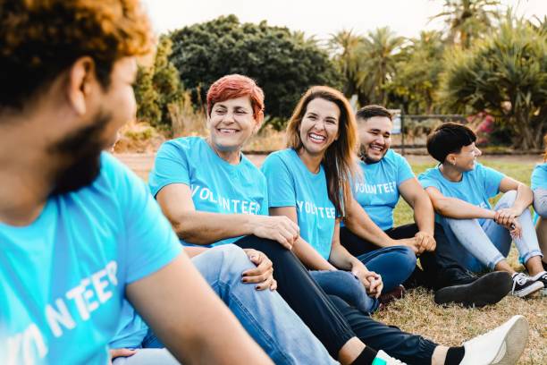istock Volunteer: Multi ethnic people having fun together outside. International team group support and help each other 2160654832