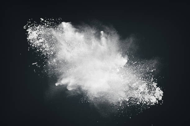 istock Abstract dynamic cloud of white dust particles dispersing against black smoke background in explosion. Design element creative collage. 2160657670
