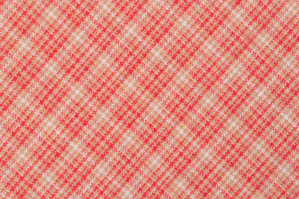 Red with white color texture of checkered fabric as background.