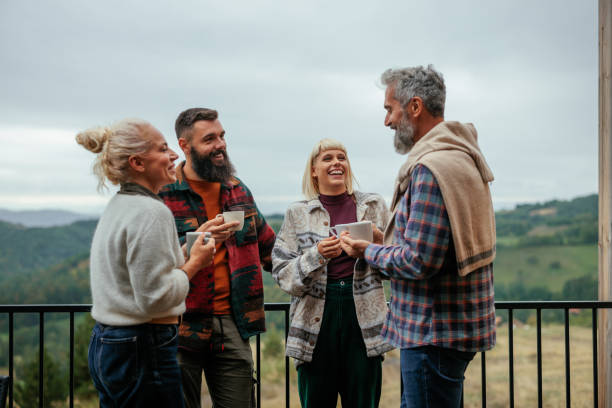 Cheerful friends spend time together in mountains.