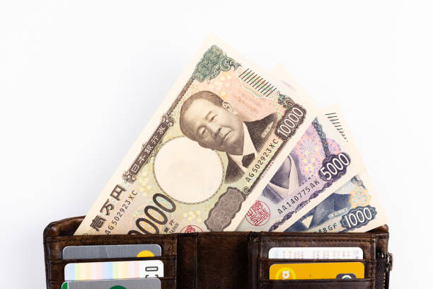 New 2024 Japanese Yen bank notes displayed sticking out of a wallet.  Updated for the first time in 20 years, now feature Shibusawa Eiichi on the ¥10,000 banknote, Tsuda Umeko on the ¥5000 banknote, and Kitasato Shibasaburo on the ¥1000 banknote.