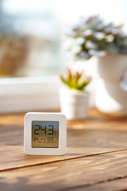 istock Digital Thermometer Displaying Temperature and Humidity Near Window 2160677057
