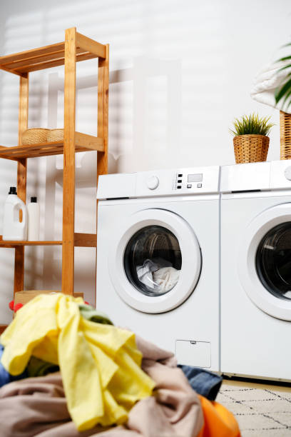 istock Laundry Day in a Modern Home With White Washers and a Wooden Shelf 2160677441