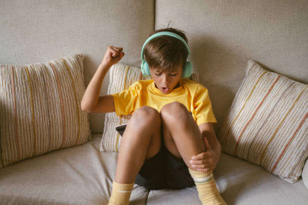 istock Little boy enjoying his free time using digital tablet has happy emotion 2160677818