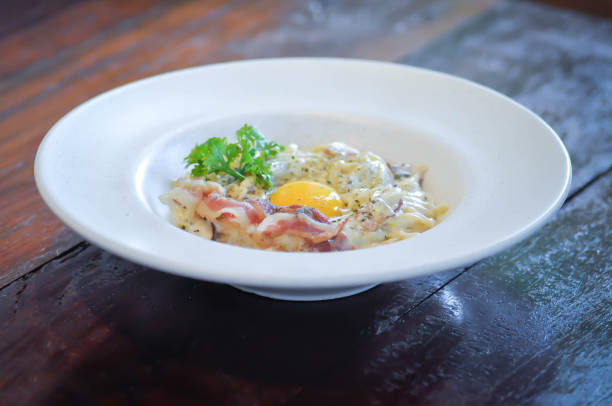 Delicious pasta Carbonara with bacon on plate, closeup