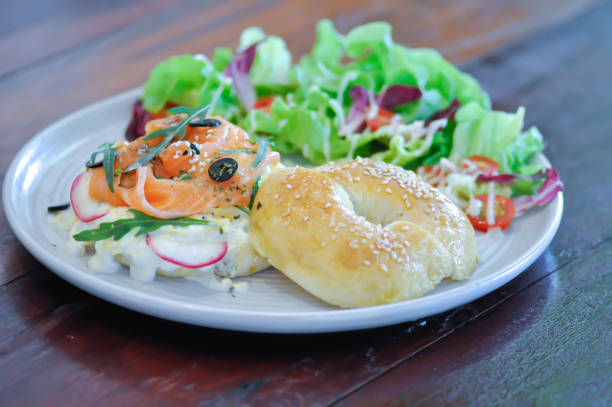 smoke salmon bagel, salmon bagel with salad for serve