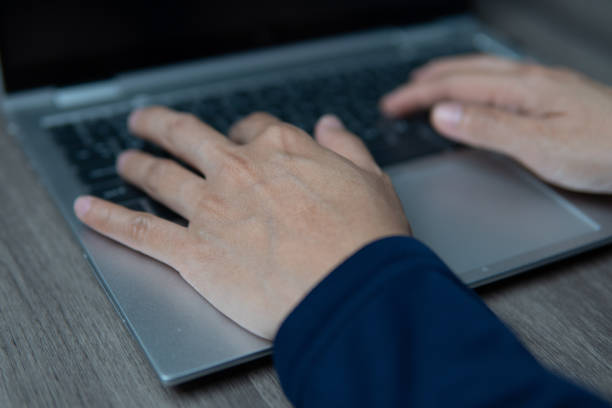 istock A close-up image of a person's hands typing on a laptop keyboard. 2160679666