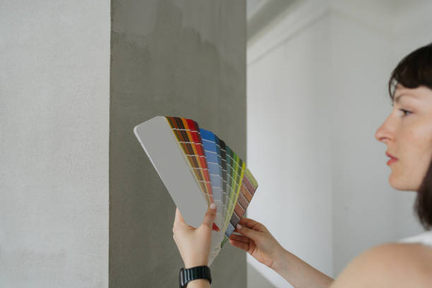 istock Choosing paint shade from a colour swatch 2160679790
