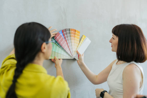 istock Choosing paint shade from a colour swatch 2160679806