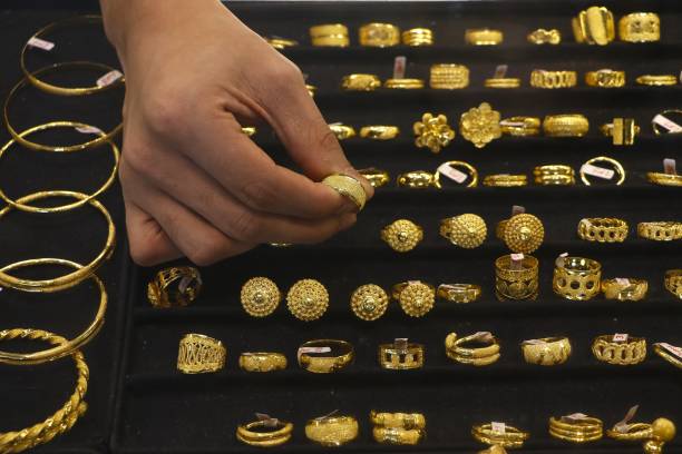 istock Jeweler man choosing the ring standing on the stand 2160681091