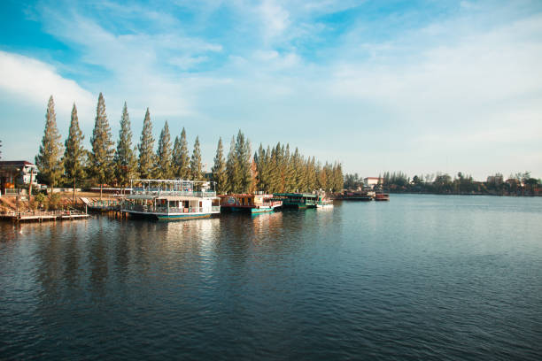 istock A serene river scene with boats docked by a pier and trees lining the shore 2160683243