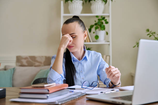 istock Tired businesswoman having problems sitting at desk with laptop 2160685053