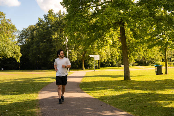 istock Young adult man is running in park 2160687026