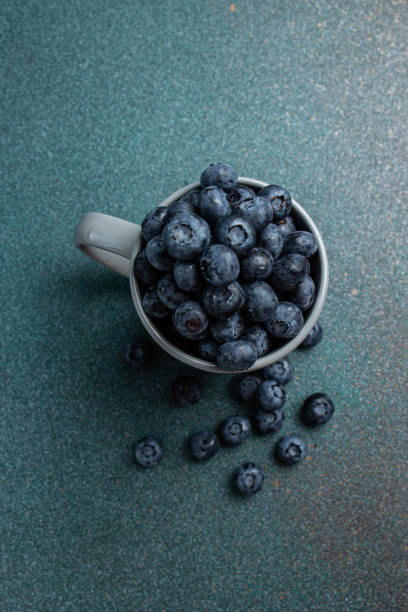 istock Blueberries in a cup on a dark background. 2160688353