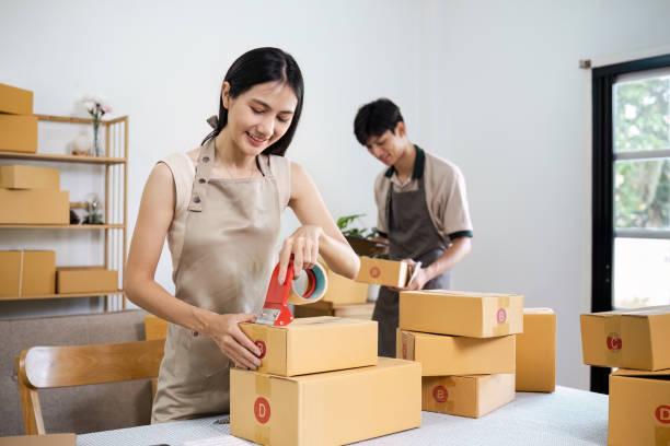 istock Young Entrepreneurs Packing Boxes for Online Small Business in a Modern Home Office Setting 2160691059