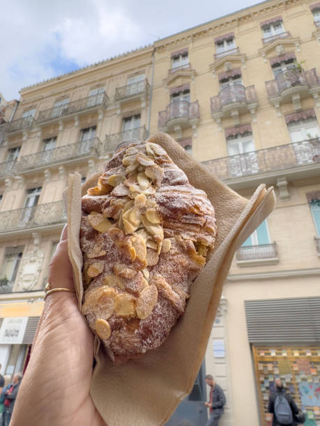 istock crispy croissant with almond on hand over street 2160692182