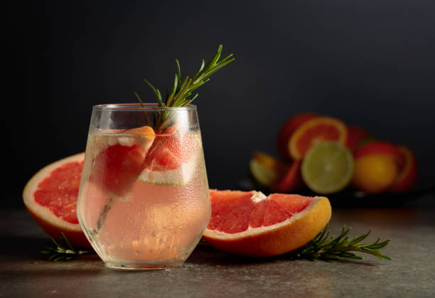 istock Cocktail gin tonic with ice, rosemary, and grapefruit on a stone table. 2160692667