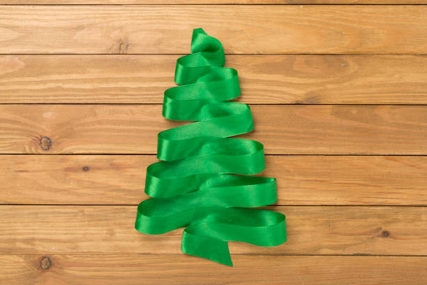 Creative ribbon christmas tree on wooden background, top, view