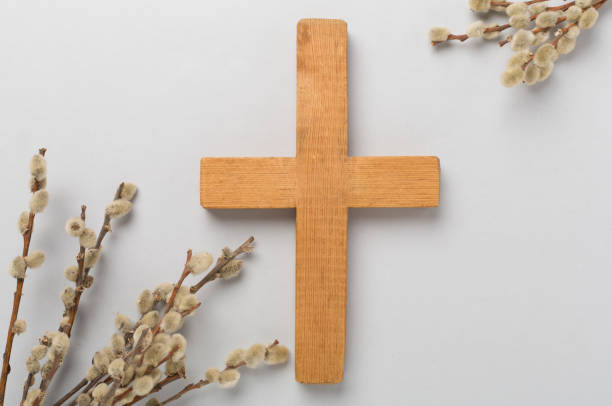 istock Cross with willow branches on color background, top, view. Palm Sunday concept 2160694407