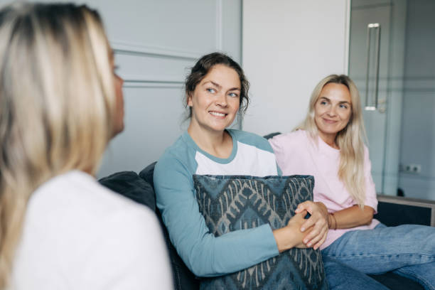 istock Happy smiling beautiful middle-aged women talking while sitting on the sofa. 2160694880